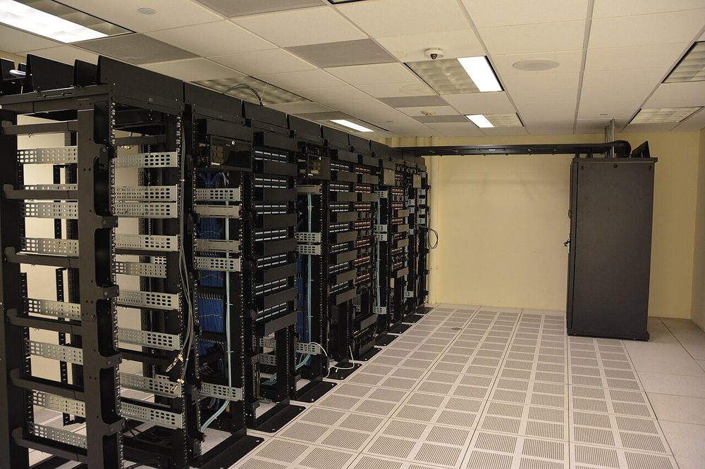 Rows of server racks in a clean, brightly lit data centre